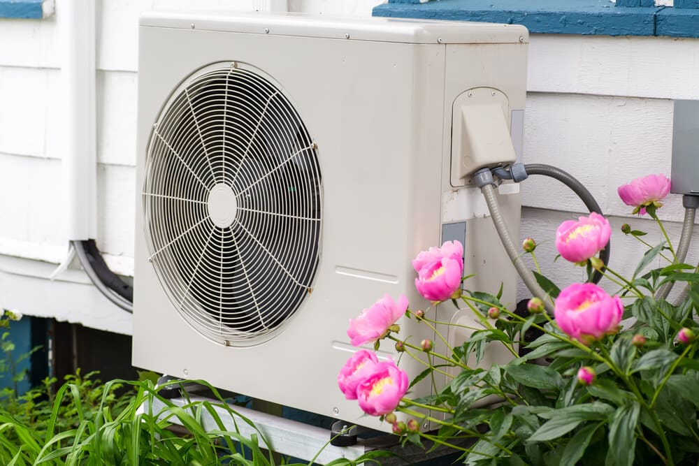 Heat pump unit on the side of a home - Buying a Commercial Pool Heat Pump