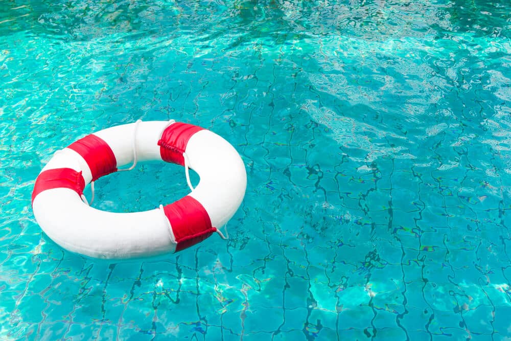 Life Ring on blue water at the swimming pool. - Pool Safety Rules 101