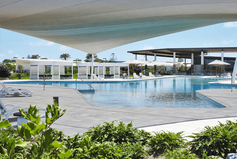 A luxurious outdoor pool area with modern lounge chairs